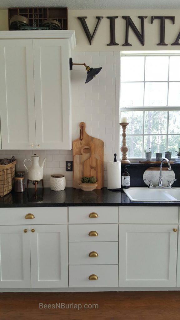 white cabinets sconce light industrial gold hardware kitchen