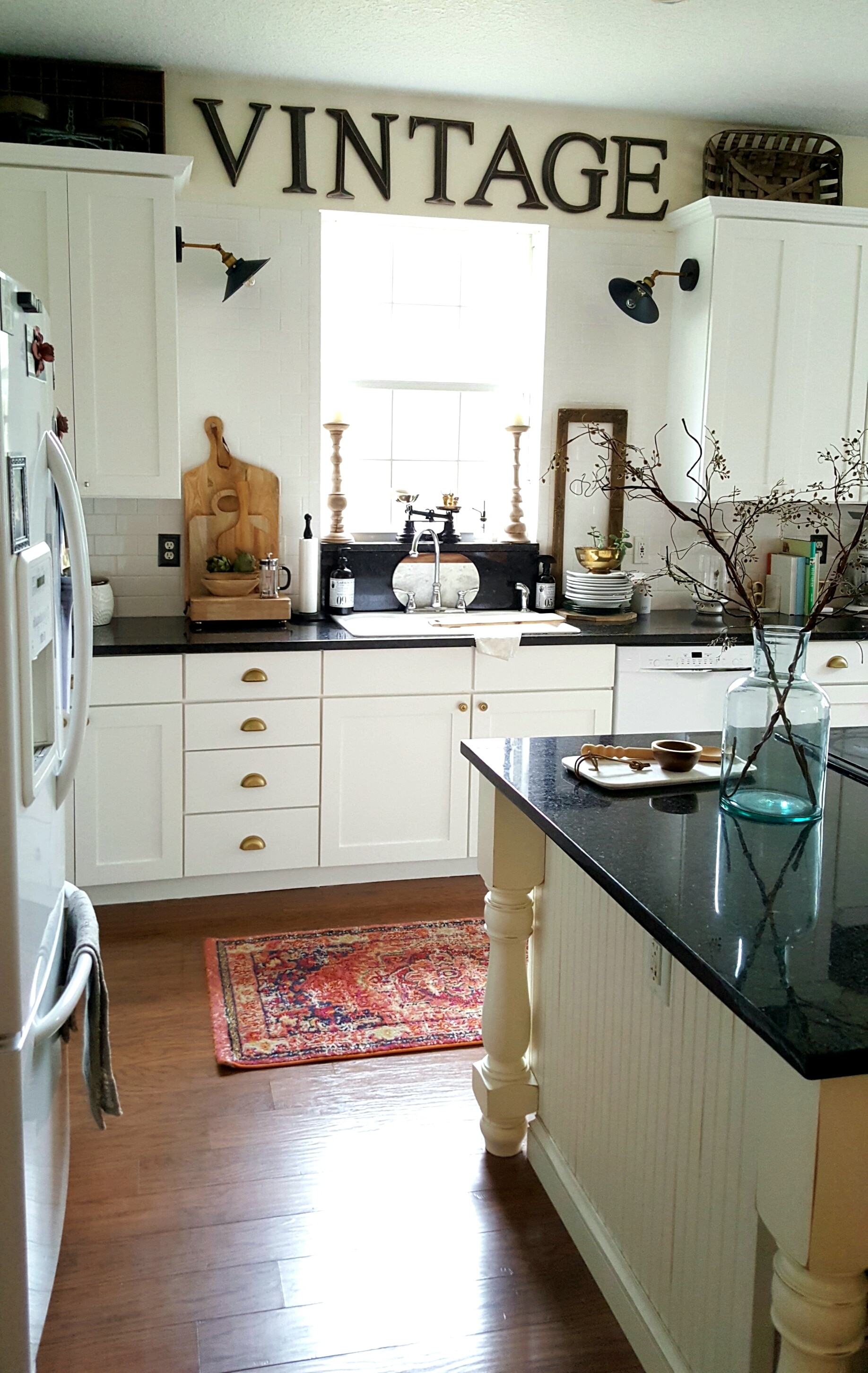 White Industrial Farmhouse Kitchen makeover painted cabinets Boho eclectic Rug Brass