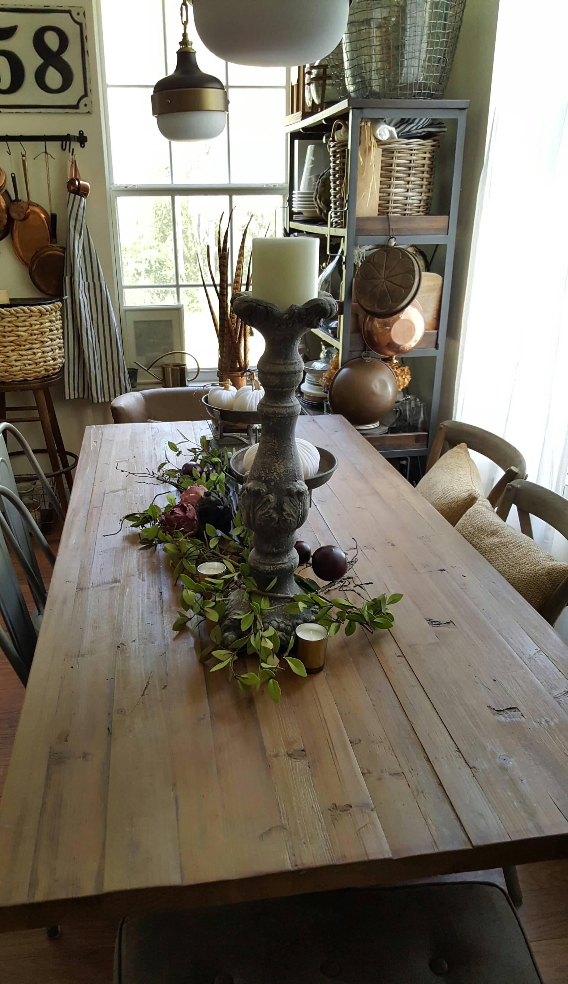 wood dining table fall decor artichokes and pumpkins