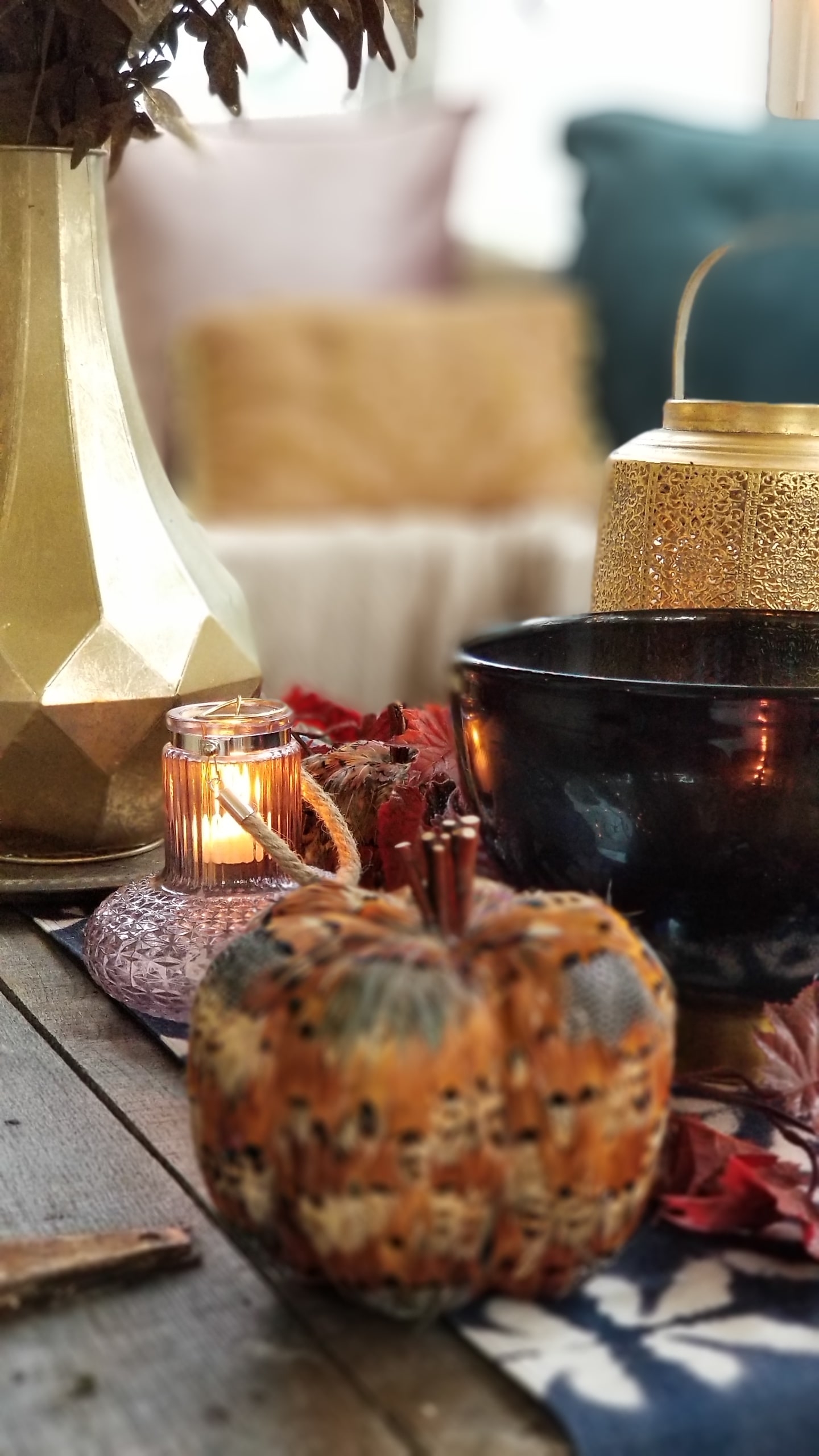 Fall At Home Decor Store Design Inspiration Back Porch Bohemian Eclectic Chic Boho Rustric retreat fur jewel tones pumpkins acorns gold lanterns candles throws pillows plants branches candles cozy wood autumn decor harvest vase 