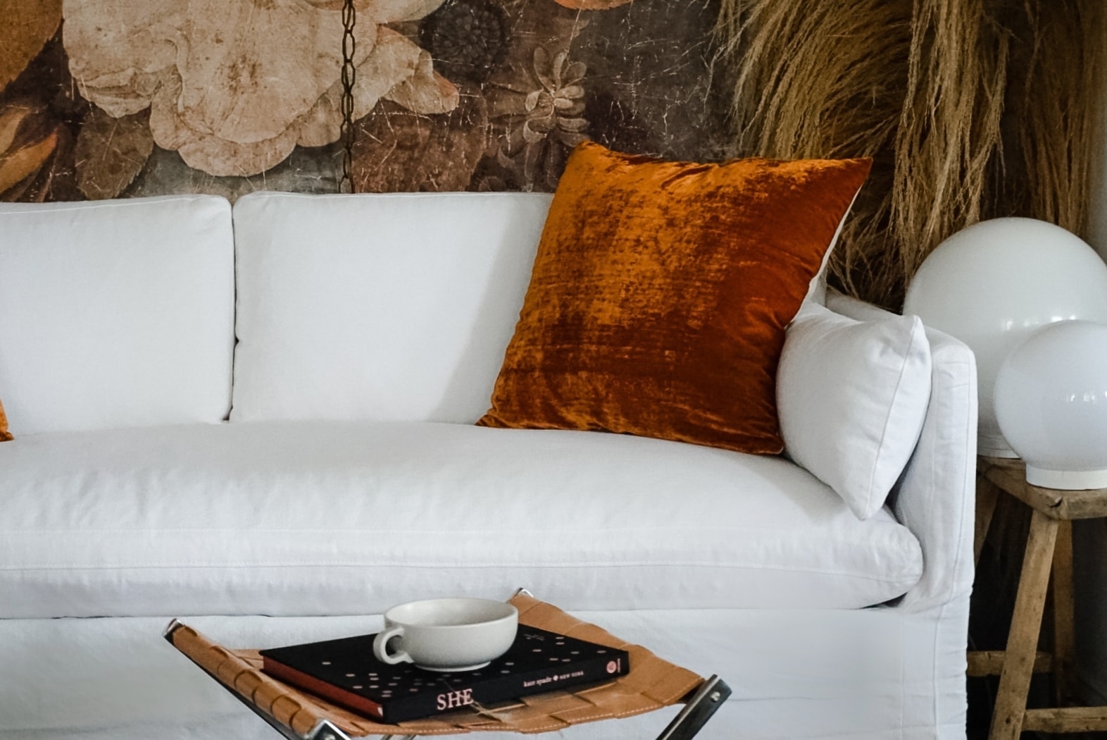 white sofa furniture slipcoverd living room decor design scandinavian mid century modern chic velvet linen eclectic farmhouse home decor interior design style winter new year style wood floors anthropologie tapestry pillows candles cozy hygge