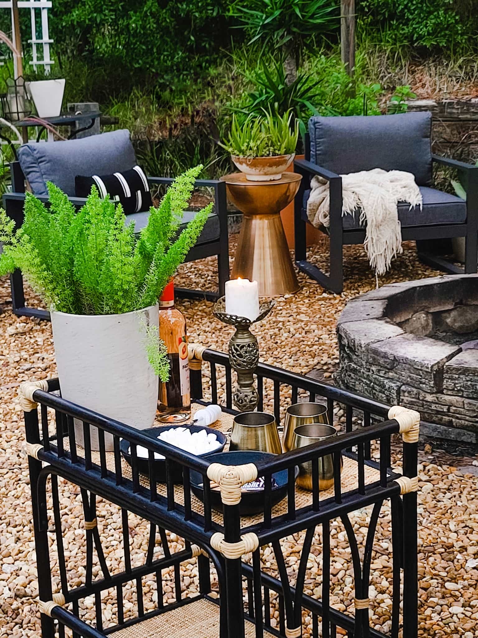 Outdoor living Firepit fireplace gravel patio firelog holder firewood pine tree patio furniture bohemian eclectic rustic farmhouse scandinavian style Countryliving Better Homes and Gardens cozy fall and winter seating entertaining bed bath & beyond 