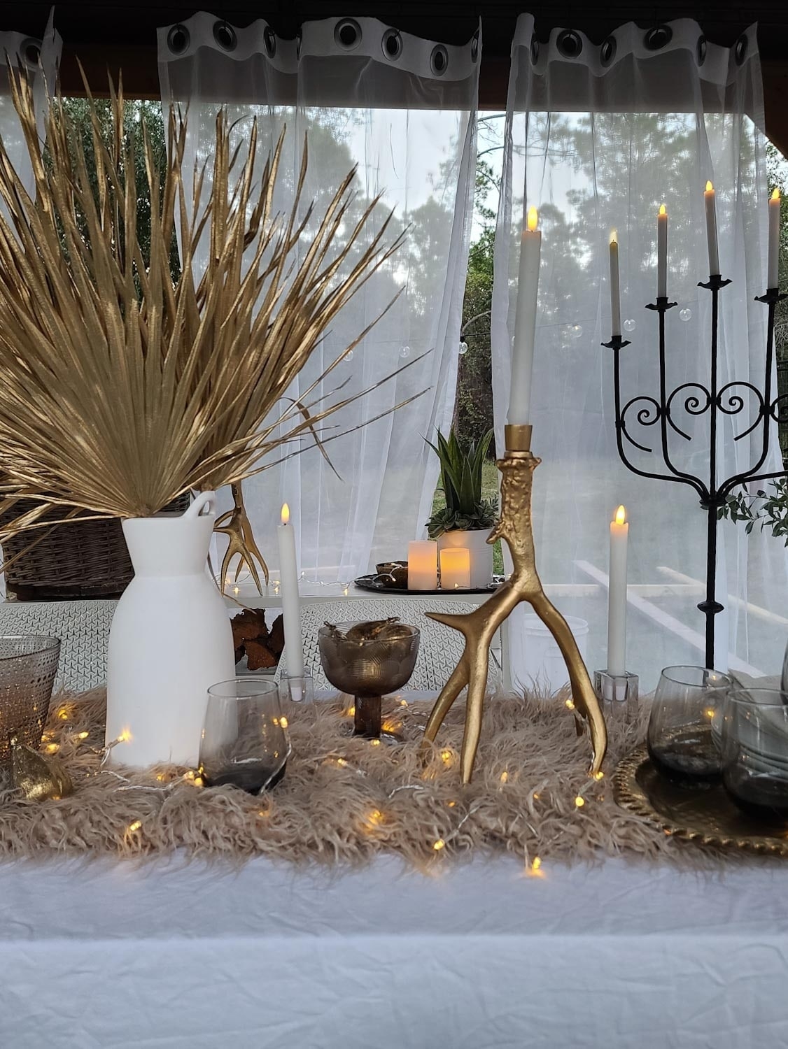 Country Living Winter Wonderland Dining space. Twinkle lights, candles, fur and antlers.