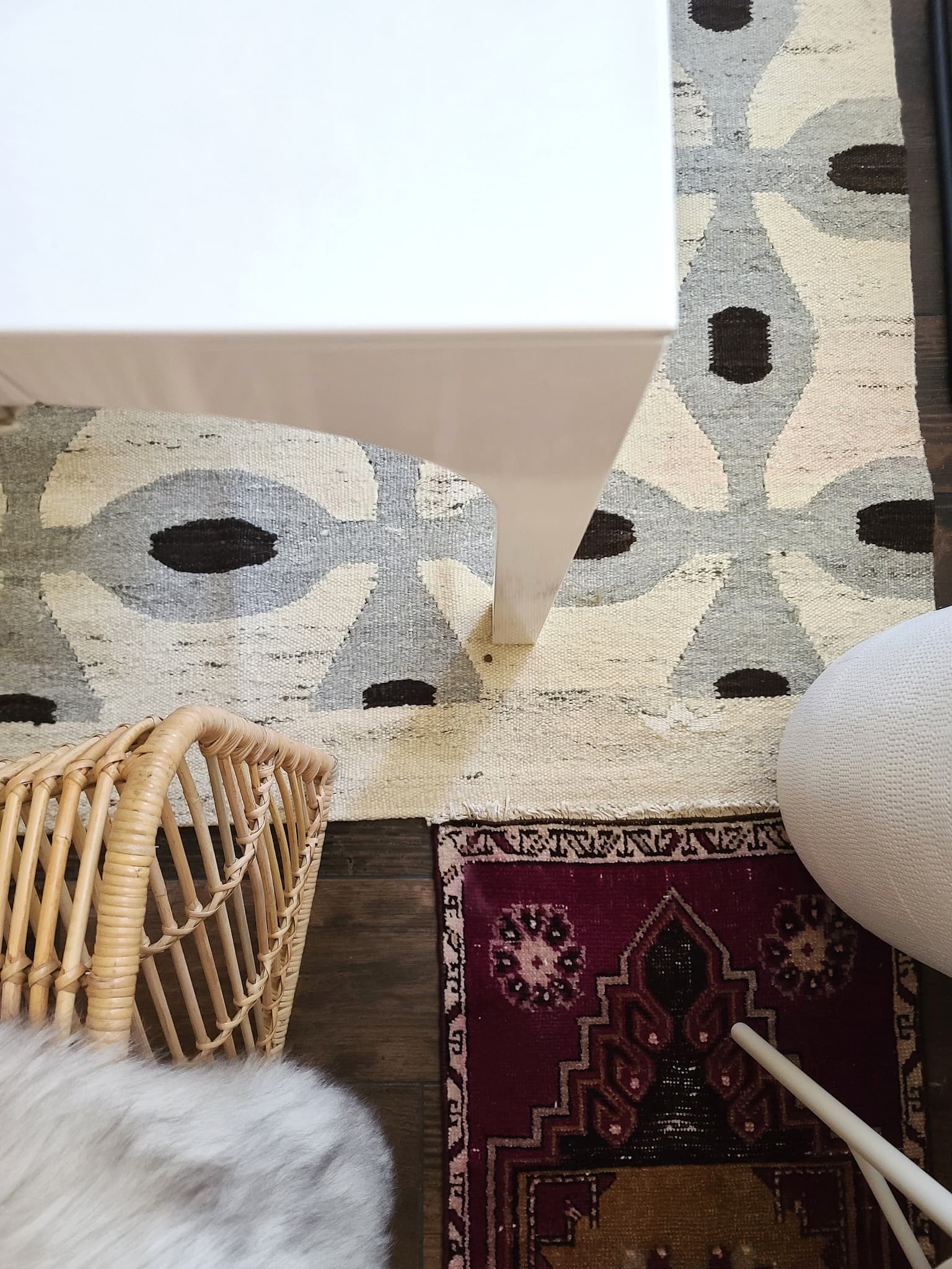 Scandinavian Modern Hygge style white dining room with candles texture woods and whites. Kitchen decor, vintage rugs, cane cabinet and open shelving.